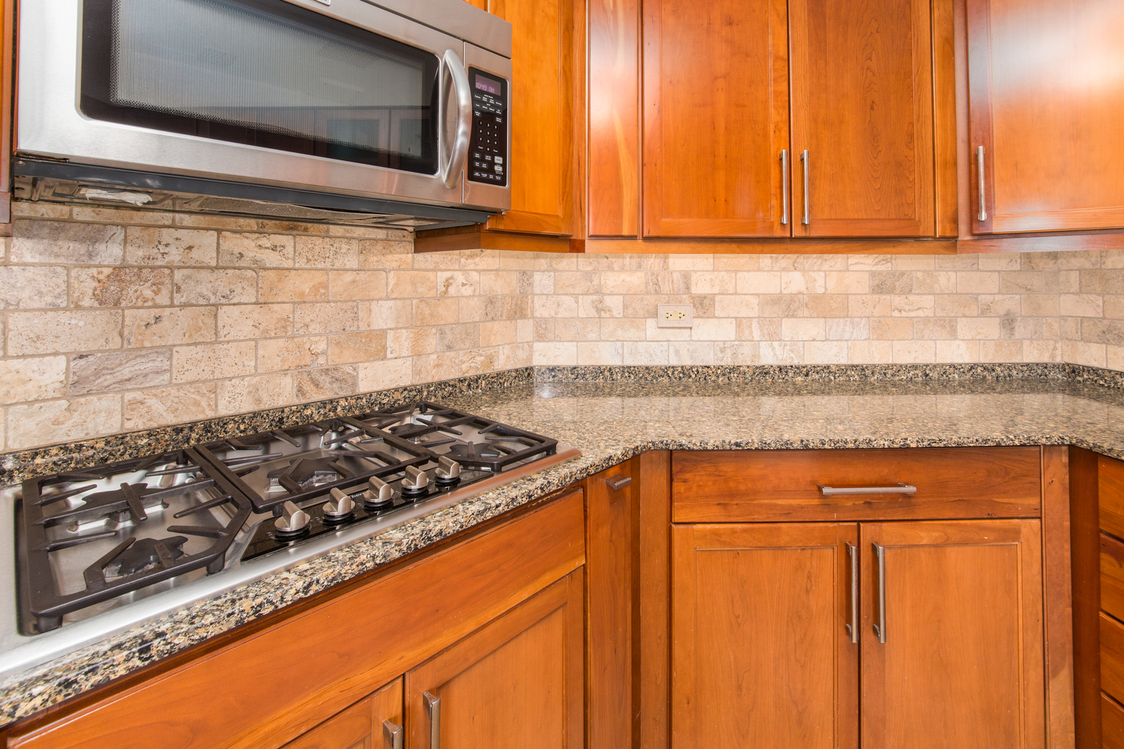 175 Boardwalk Place, Unit 301 Park Ridge, IL 60068 - Photo 8 of 20 a kitchen with wooden cabinets and a stove top oven
