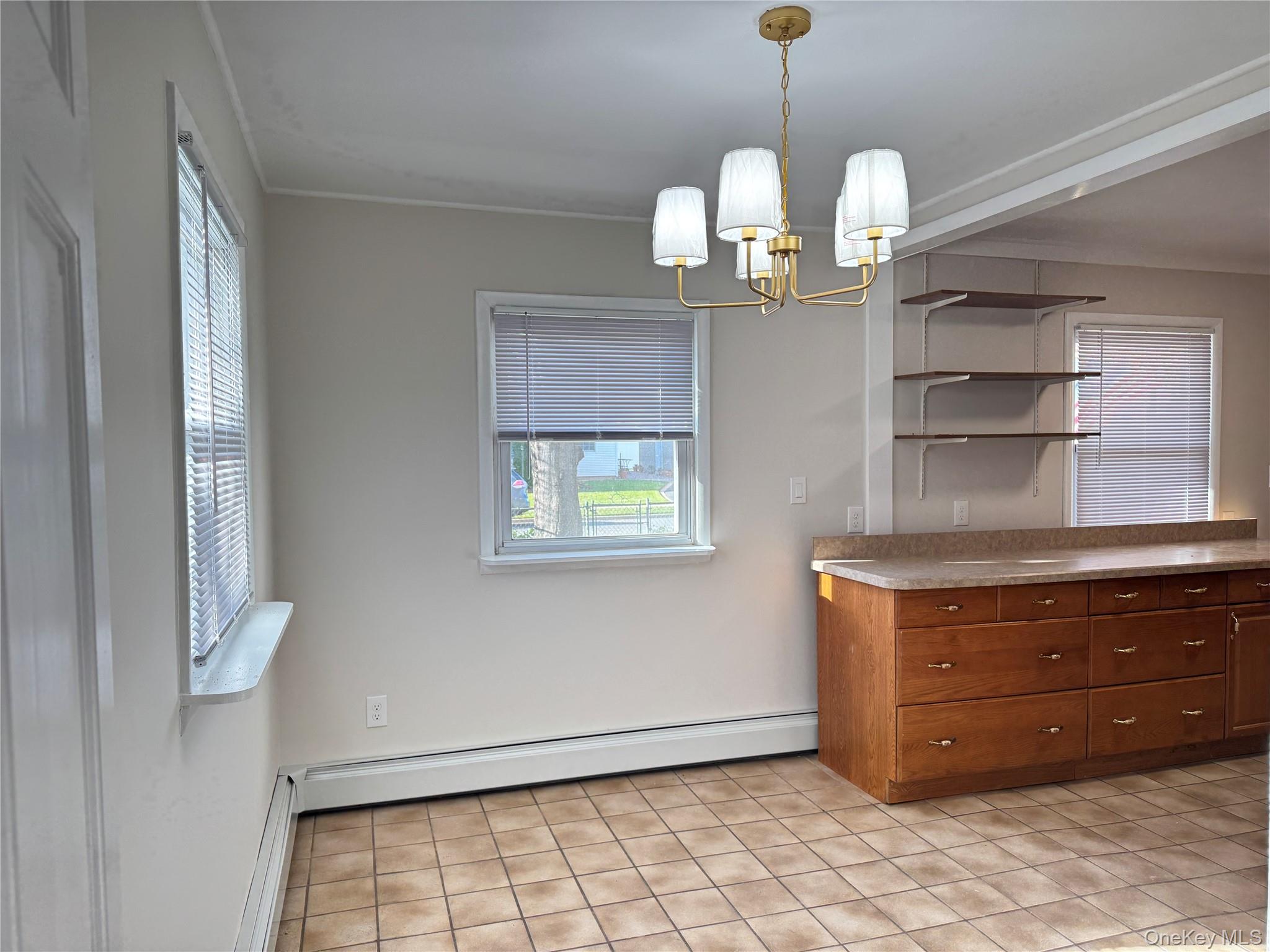 129 Spring Lane Levittown, NY 11756 - Photo 11 of 18 a room with a cabinet and a table