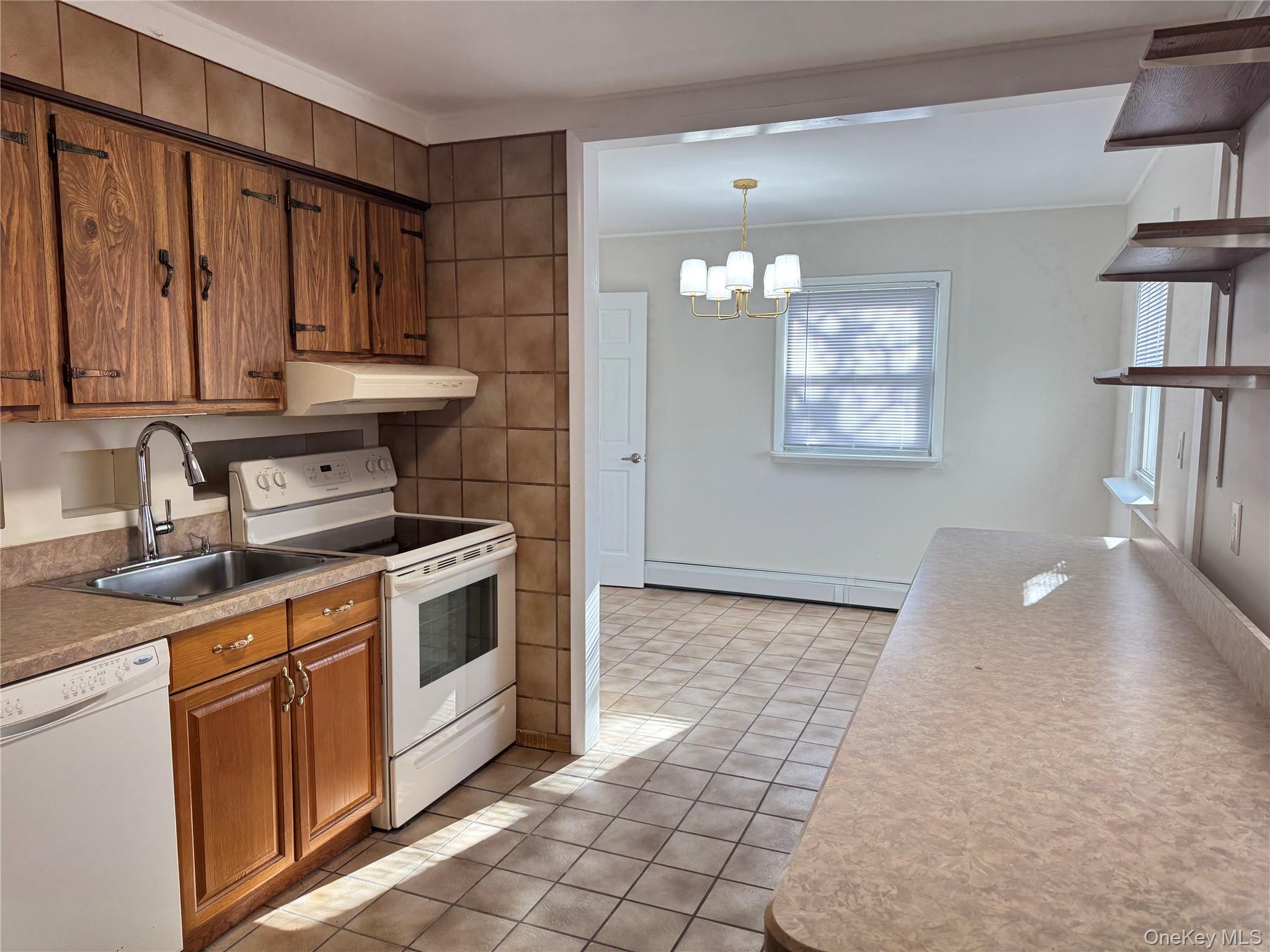 129 Spring Lane Levittown, NY 11756 - Photo 10 of 18 a kitchen with a stove and cabinets