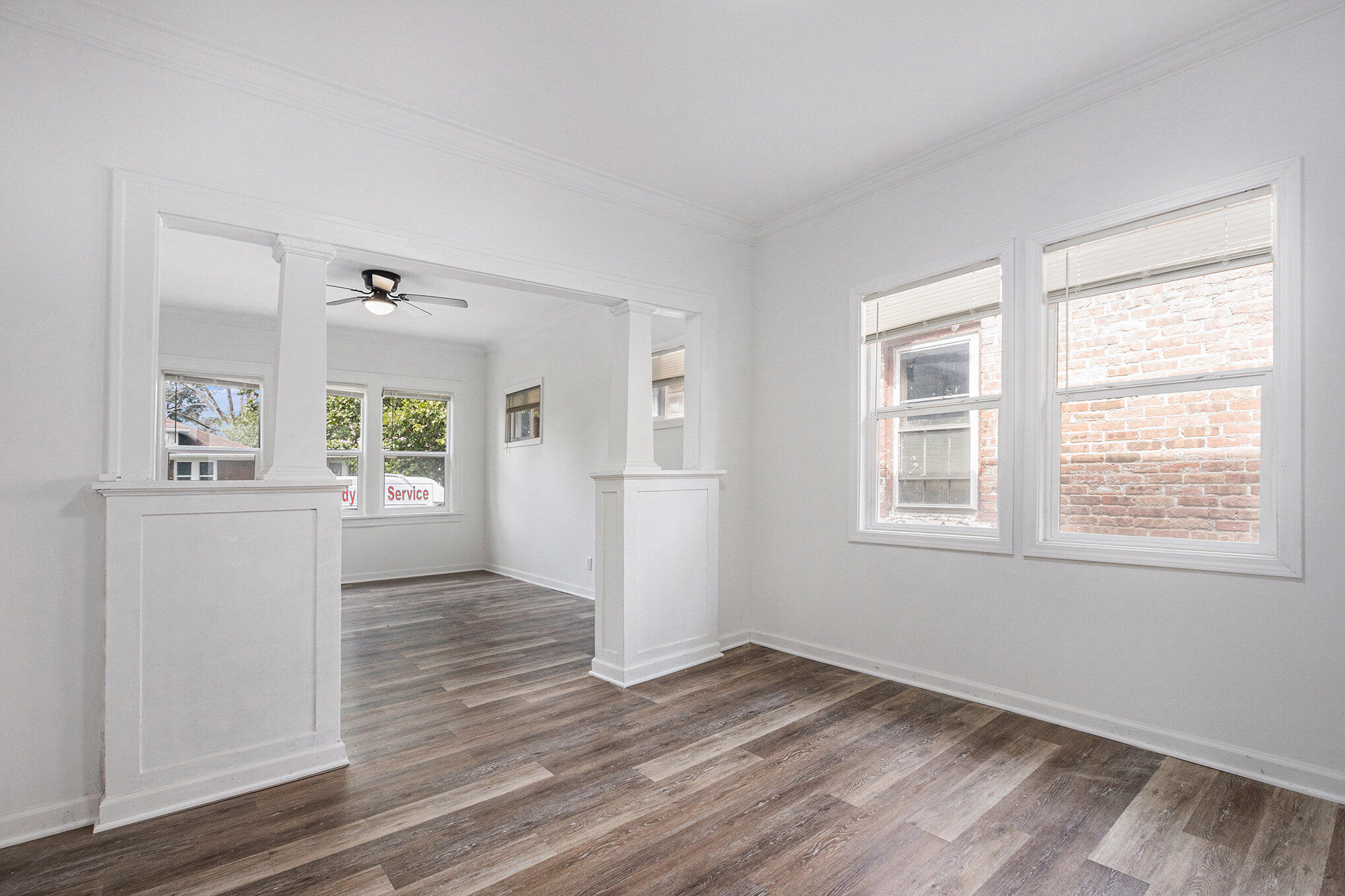 1067 Polk Street Gary, IN 46402 - Photo 2 of 13 a view of a kitchen with wooden floor and a kitchen space