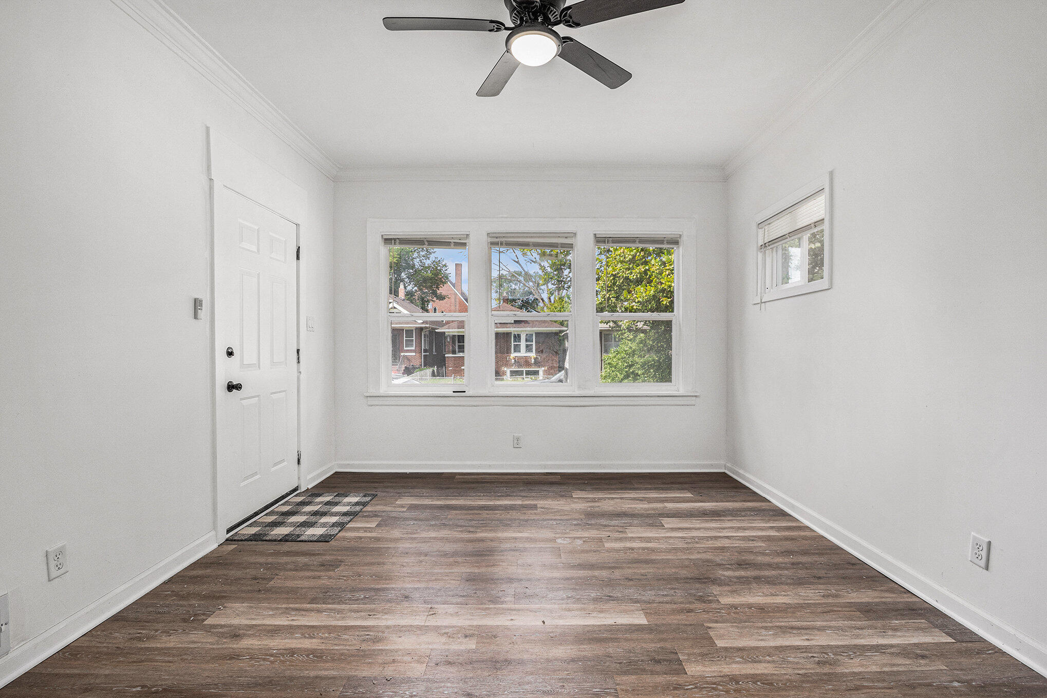 1067 Polk Street Gary, IN 46402 - Photo 6 of 13 a view of empty room with wooden floor and fan