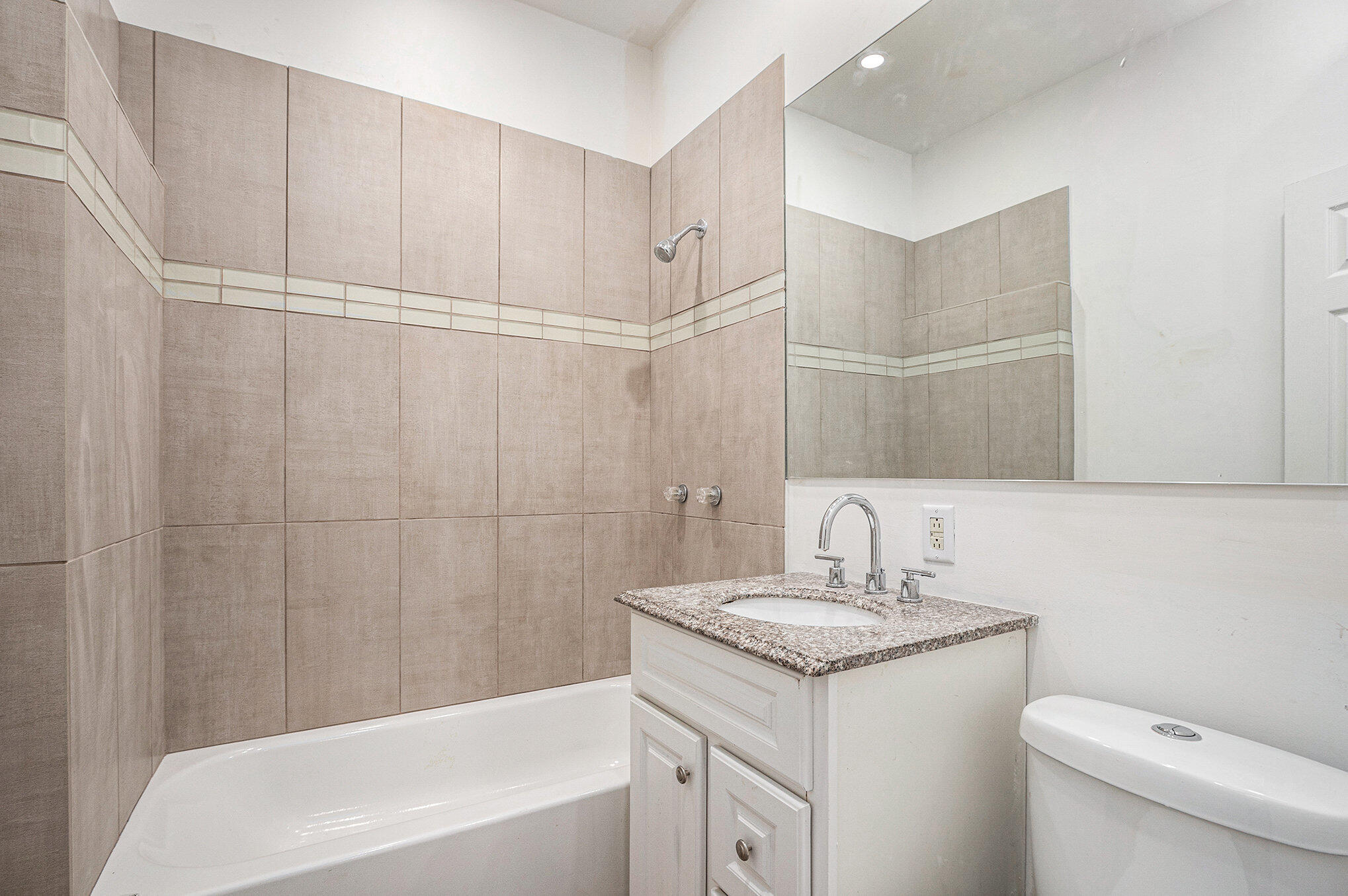 1067 Polk Street Gary, IN 46402 - Photo 10 of 13 a bathroom with a granite countertop sink a toilet and bathtub