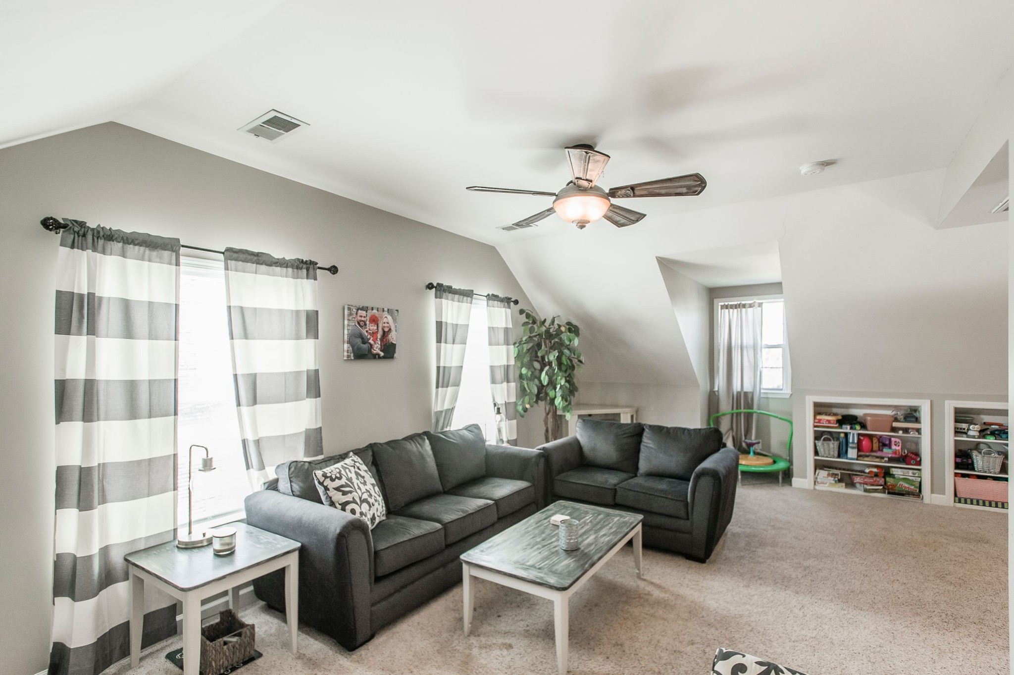 1351 Pee Dee Branch Road Cottontown, TN 37048 - Photo 49 of 59 a living room with furniture a ceiling fan and a bookshelf