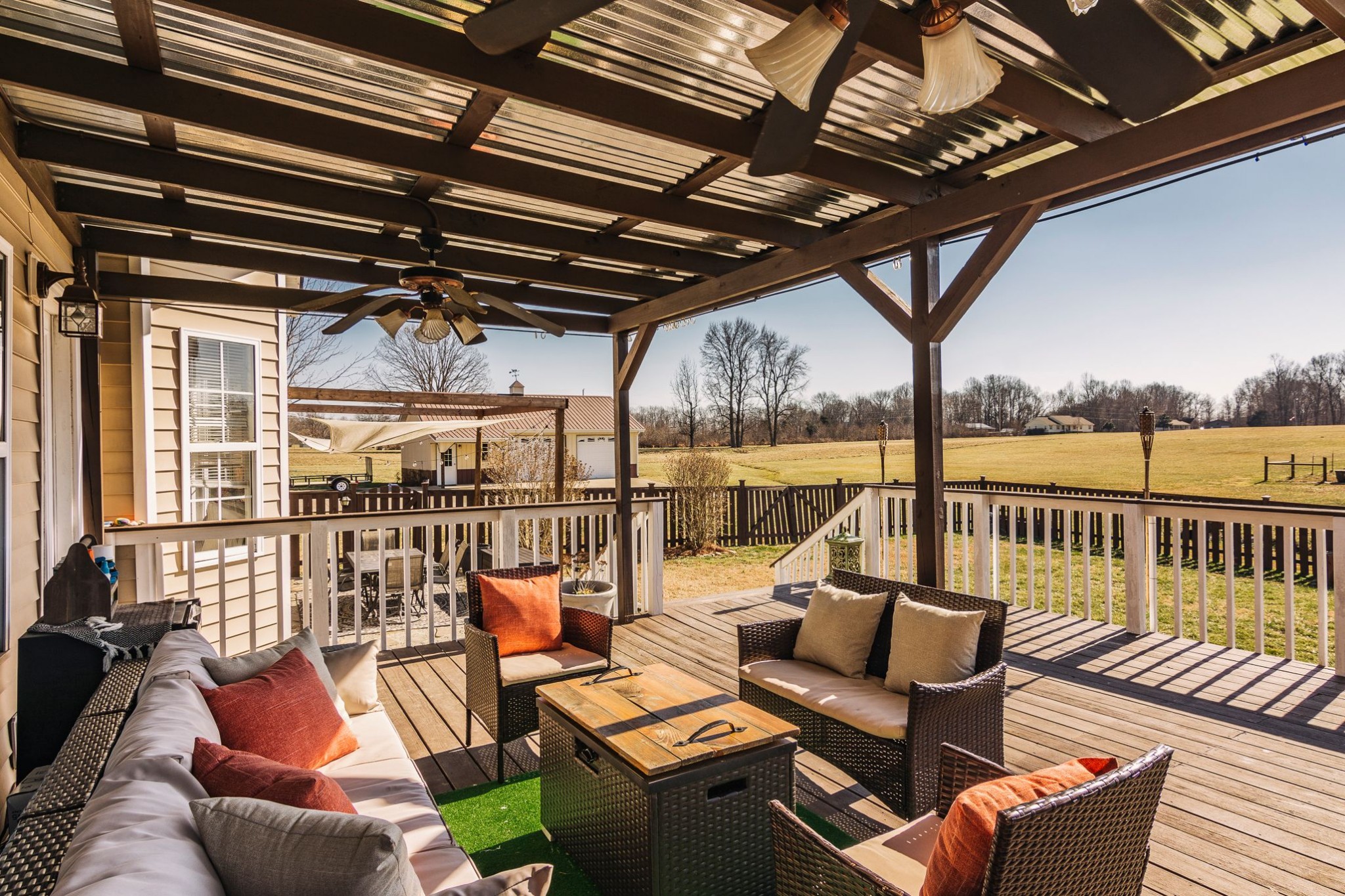 1351 Pee Dee Branch Road Cottontown, TN 37048 - Photo 9 of 59 a view of a patio with couches chairs and wooden floor