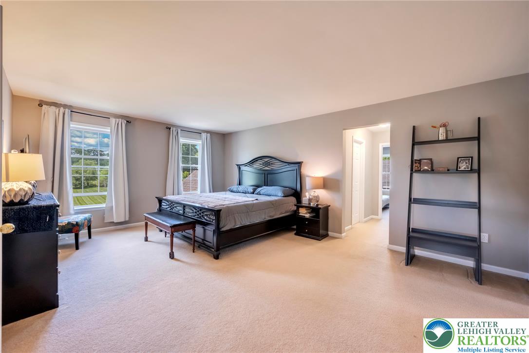 204 Bushkill Ridge Road Wind Gap, PA 18091 - Photo 25 of 48 A generously proportioned sleeping sanctuary, illuminated by natural light and offering a serene view of the surrounding landscape.