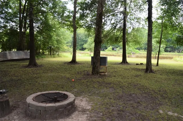 a view of a house with backyard and sitting area