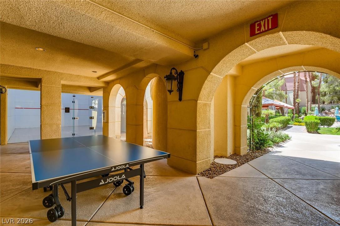 230 East Flamingo Road, Unit 334 Las Vegas, NV 89169 - Photo 35 of 37 Arched stucco pillars frame a sheltered recreational area overlooking the lush communal grounds.