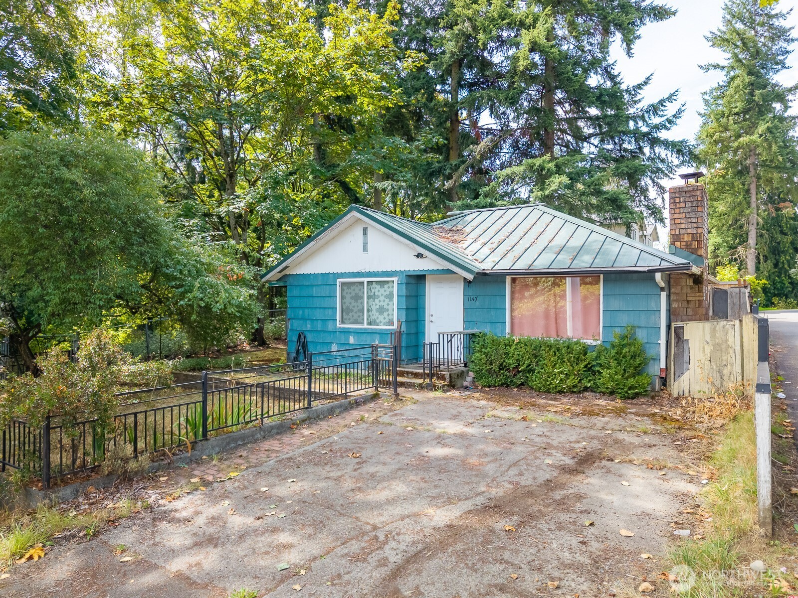 a front view of a house with a yard and fence