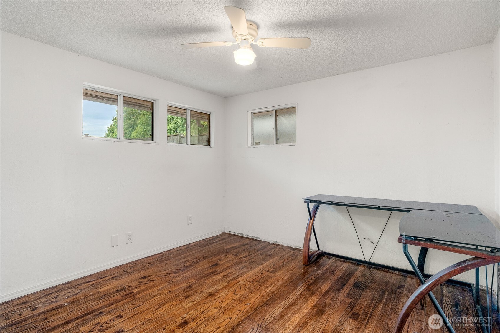 1147 Aberdeen Avenue Northeast Renton, WA 98056 - Photo 4 of 24 a view of a hallway with wooden floor and a ceiling fan