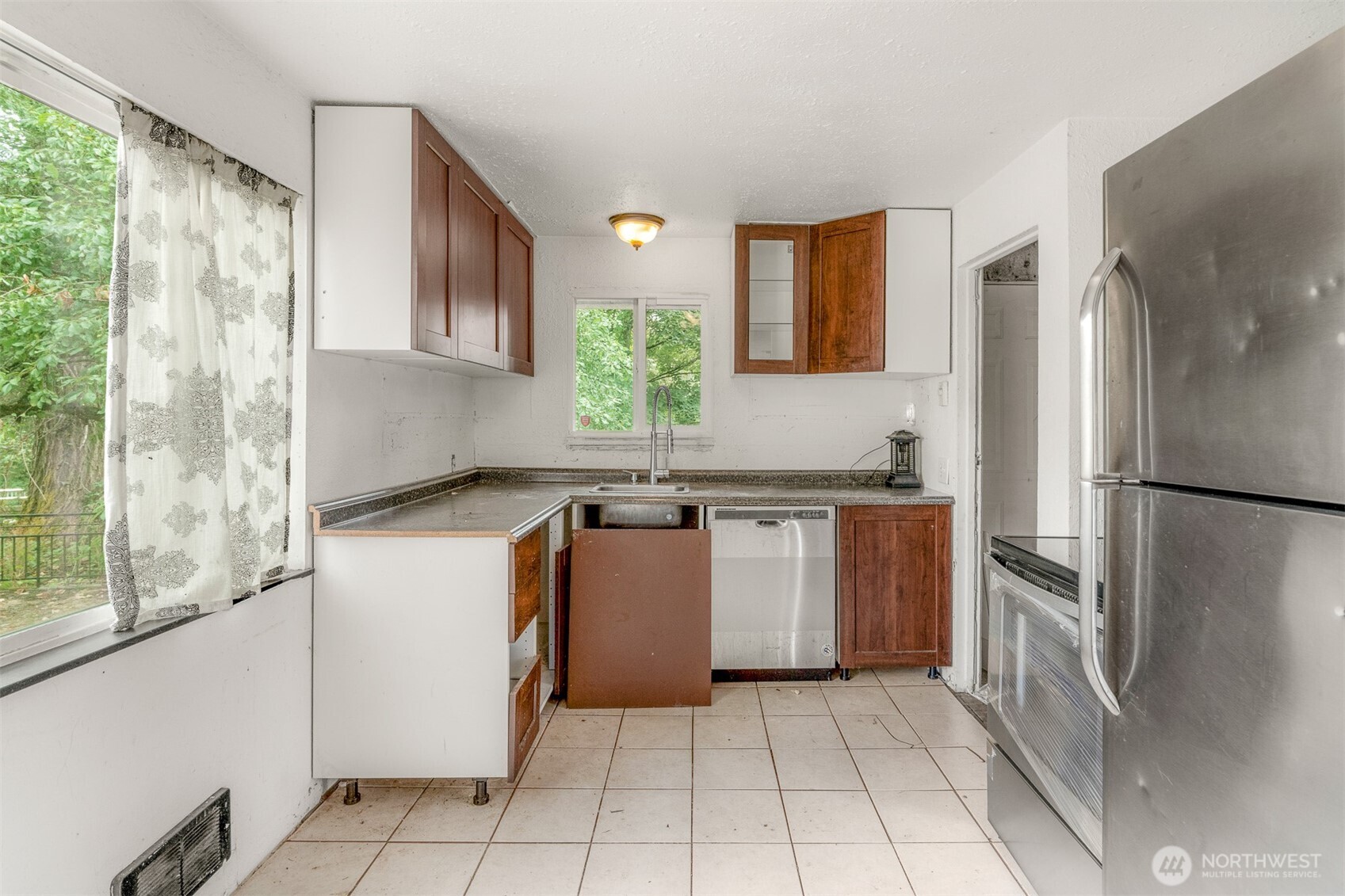 1147 Aberdeen Avenue Northeast Renton, WA 98056 - Photo 7 of 24 a kitchen with a refrigerator and a sink