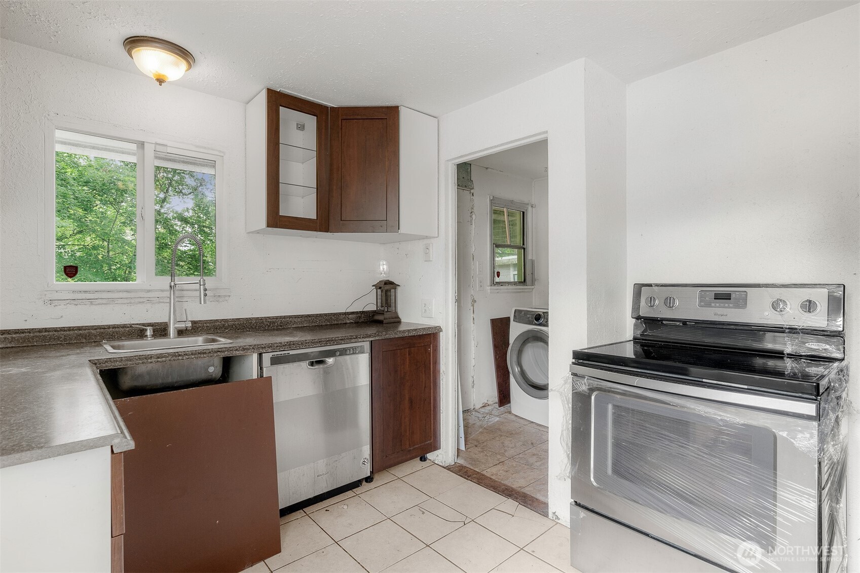 1147 Aberdeen Avenue Northeast Renton, WA 98056 - Photo 9 of 24 a kitchen with a stove a sink and a microwave