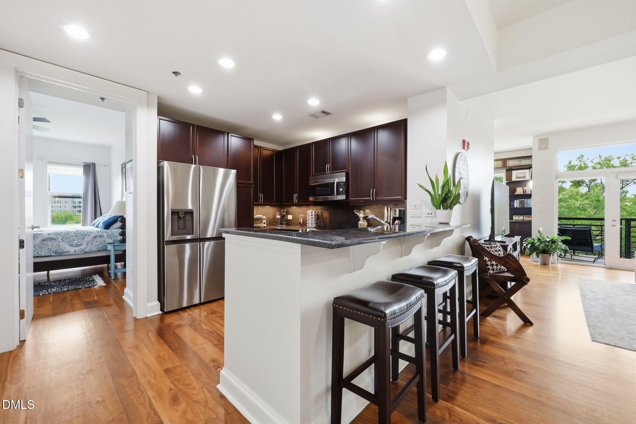 618 North Boylan Avenue, Unit 718 Raleigh, NC 27603 - Photo 15 of 38 a kitchen with refrigerator a sink and chairs