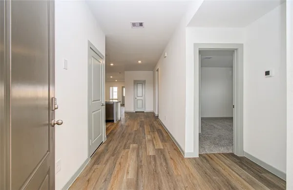a view of a hallway view with wooden floor and staircase