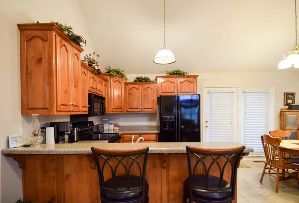 a kitchen with stainless steel appliances granite countertop a sink a stove and a refrigerator