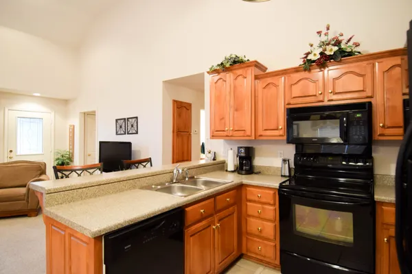 a kitchen with a sink stove and microwave