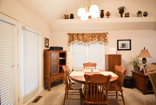 a view of a dining room with furniture and window