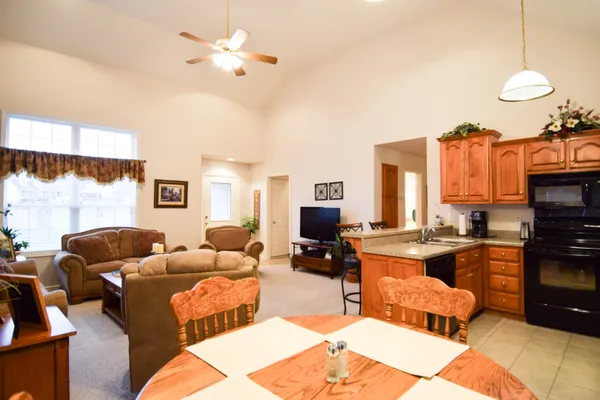 a living room with furniture a fireplace and a chandelier