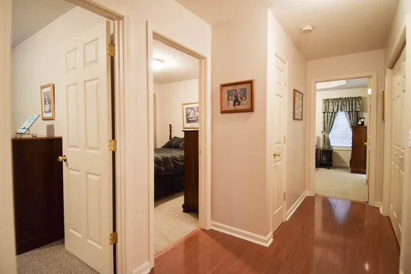 a view of a hallway with bathroom and bathroom