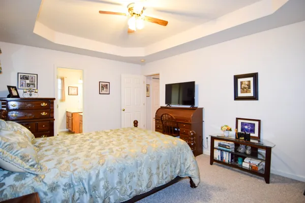 a bedroom with a bed and a tv