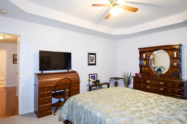 a bedroom with a bed and a television