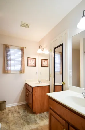 a room with a sink cabinets and a window
