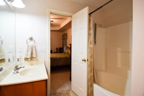 a en suite bathroom with a sink and a mirror