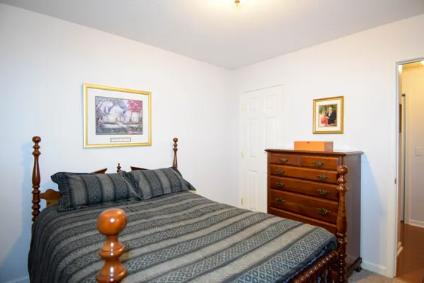 a bedroom with furniture and wooden floor