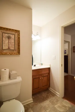 a bathroom with a toilet sink and mirror