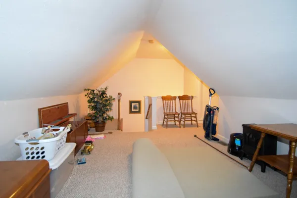 a bed room with a bed and a chair