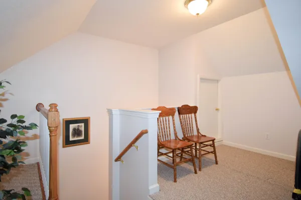 a view of staircase with furniture and a potted plant