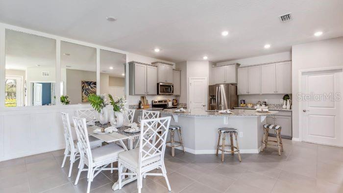 18391 Tavernside Trail Lakewood Ranch, FL 34211 - Photo 13 of 41 a kitchen with a table and chairs in it