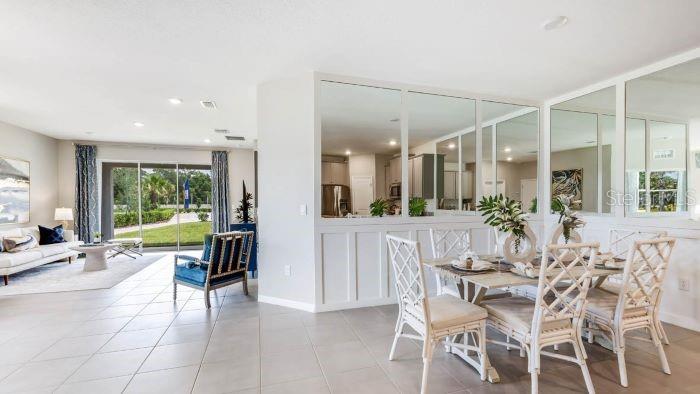 18391 Tavernside Trail Lakewood Ranch, FL 34211 - Photo 4 of 41 a view of a dining room with furniture window and outside view