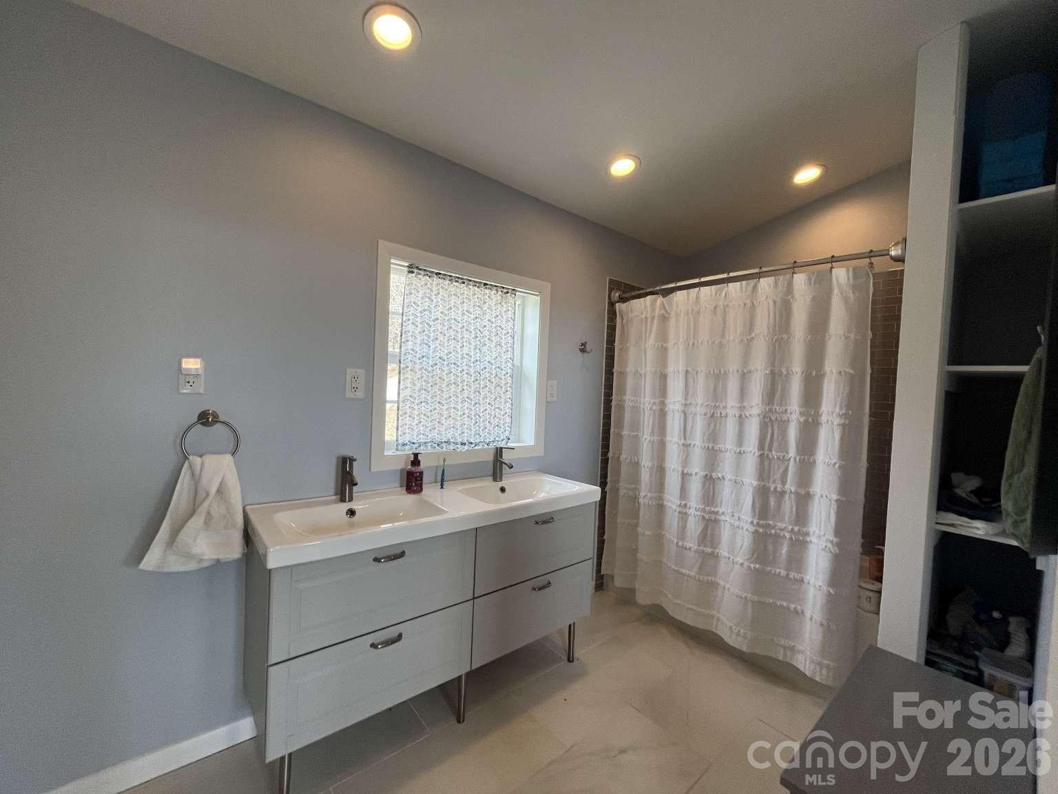 3445 Irish Hills Road Morganton, NC 28655 - Photo 23 of 34 a bathroom with a double vanity sink and a mirror