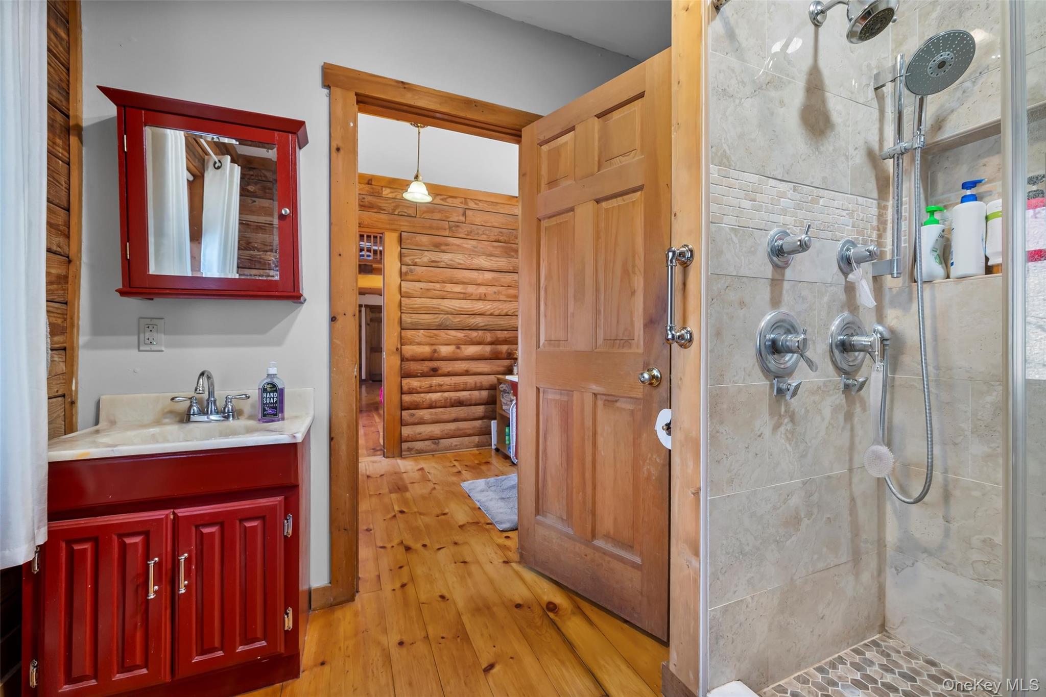 1085 County Rte 17 Montgomery, NY 12549 - Photo 40 of 50 a bathroom with a granite countertop sink a mirror and shower