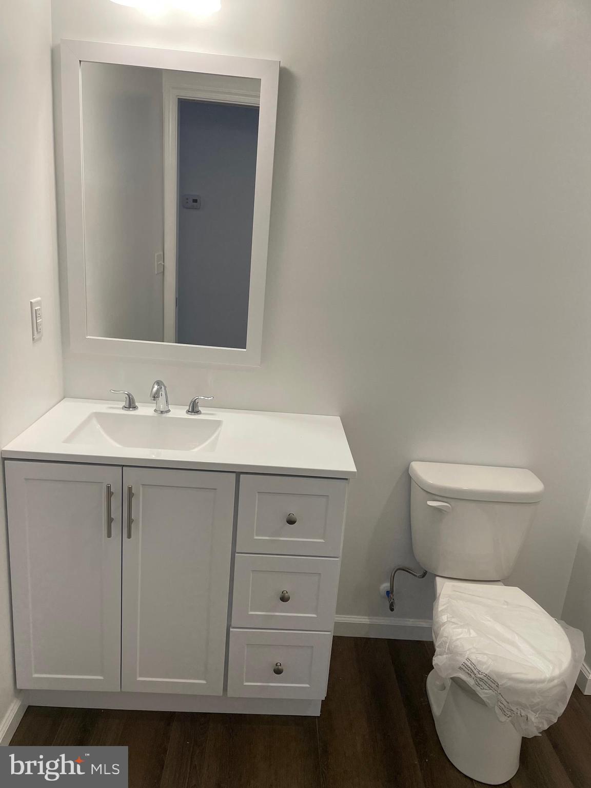 300 Collins Avenue, Unit 2 Hurlock, MD 21643 - Photo 3 of 5 a bathroom with a sink toilet and vanity