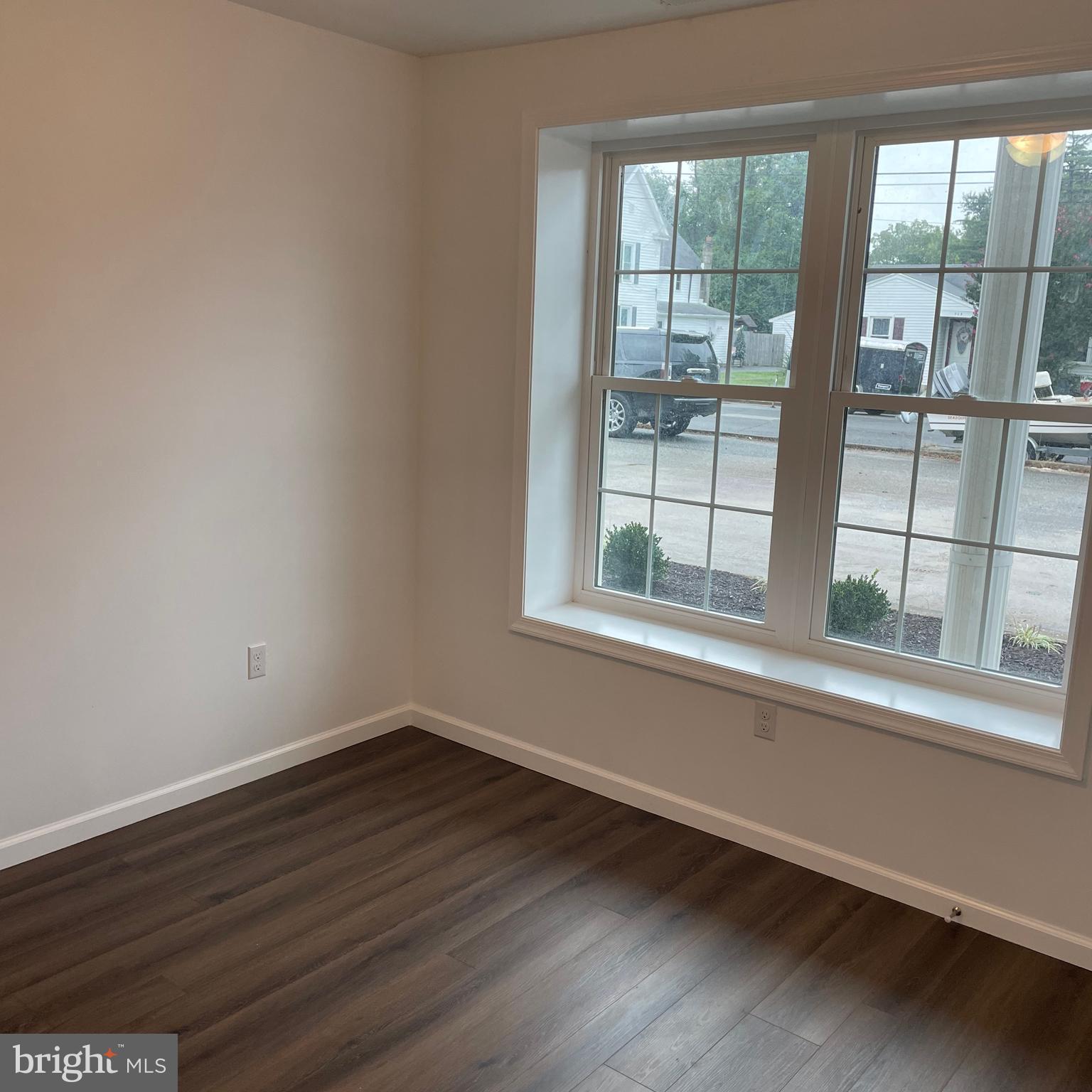 300 Collins Avenue, Unit 2 Hurlock, MD 21643 - Photo 4 of 5 a view of empty room with wooden floor and fan