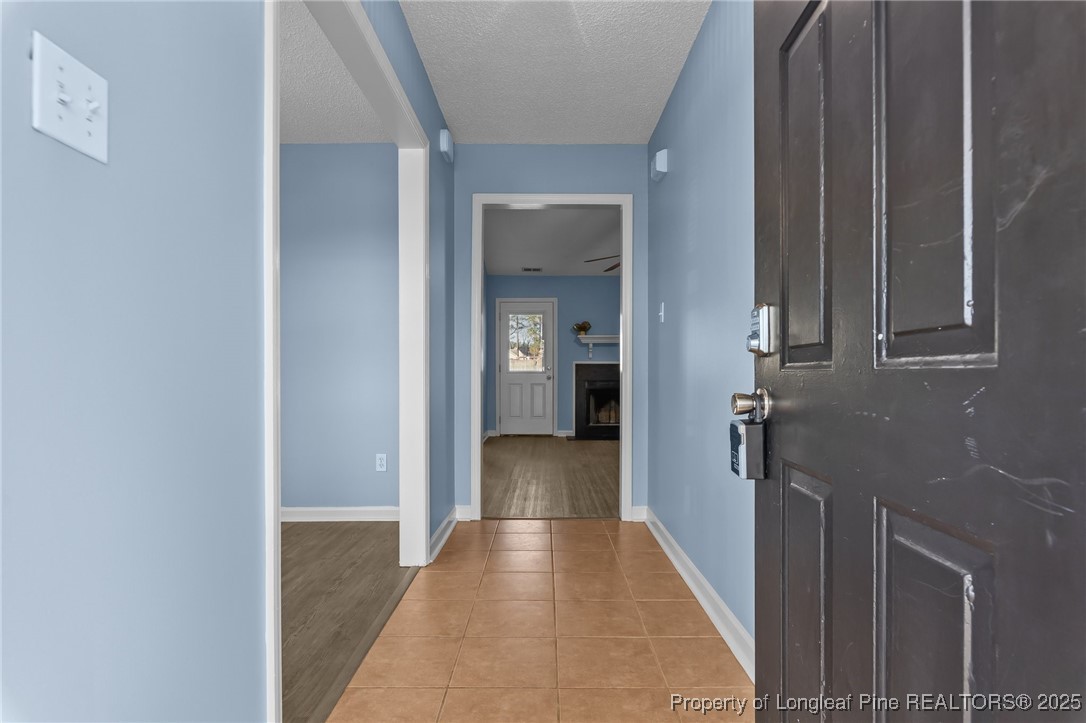 1205 Hobson Road Raeford, NC 28376 - Photo 6 of 33 a view of a hallway with a wooden shelves
