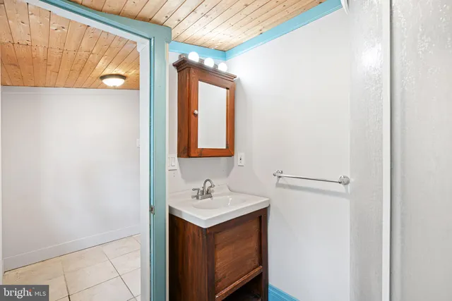 a bathroom with a sink vanity and a mirror