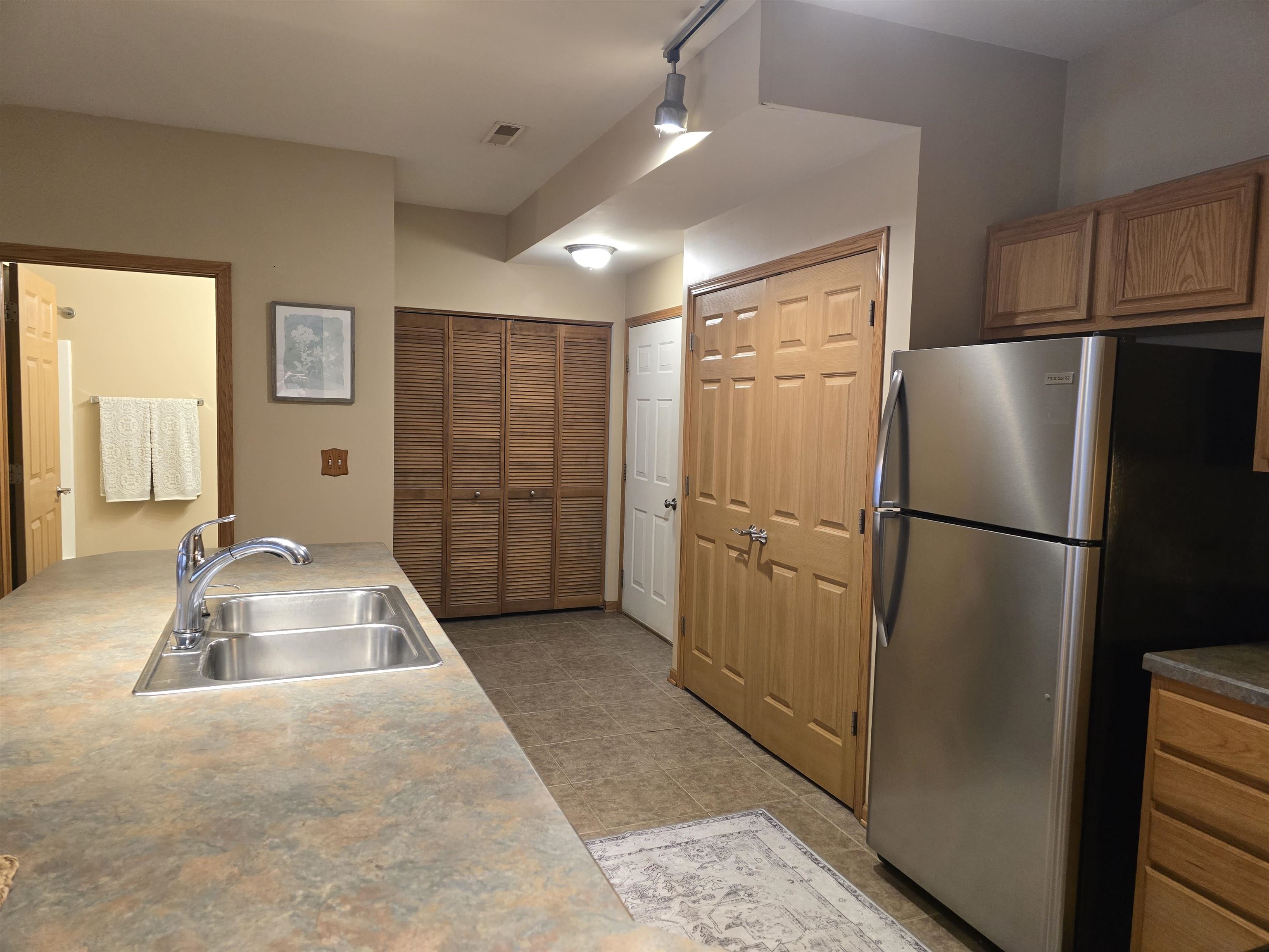 7593 Magnolia Trail Cherry Valley, IL 61016 - Photo 11 of 32 a kitchen with a refrigerator sink and cabinets