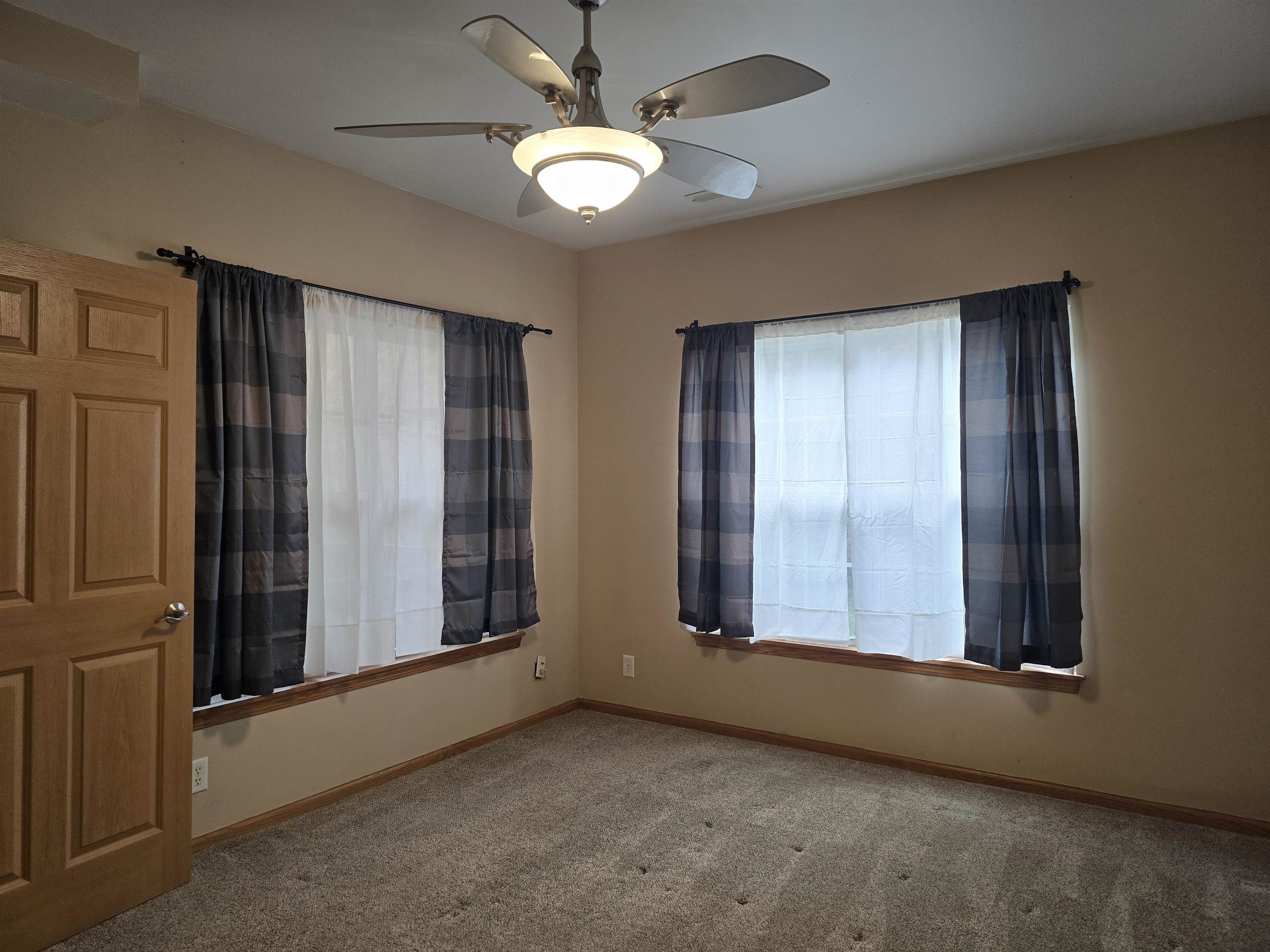 7593 Magnolia Trail Cherry Valley, IL 61016 - Photo 12 of 32 an empty room with windows chandelier fan