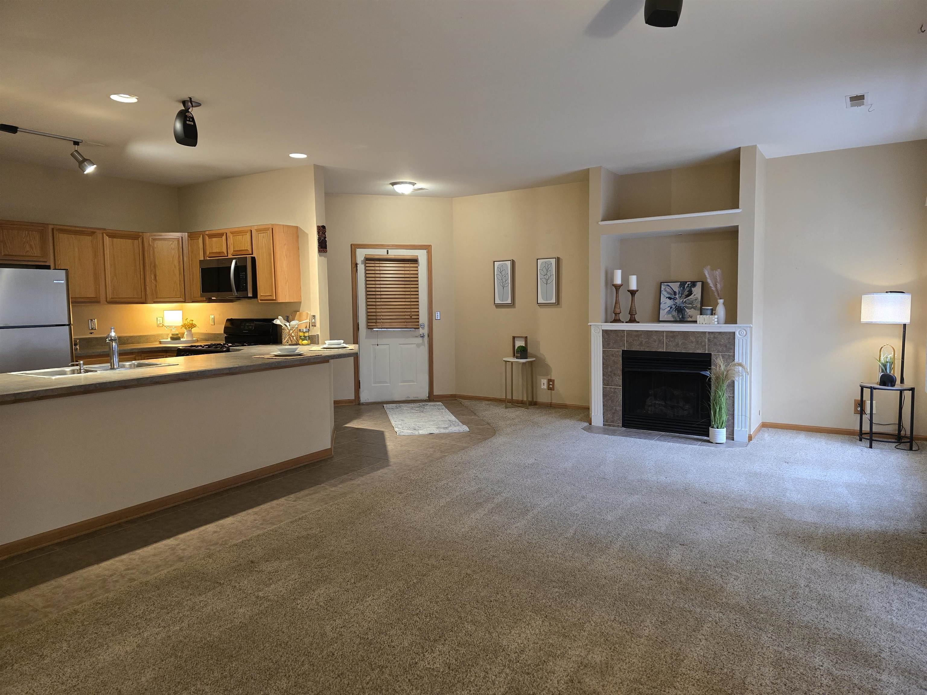7593 Magnolia Trail Cherry Valley, IL 61016 - Photo 2 of 32 a view of a kitchen with a sink and a fireplace