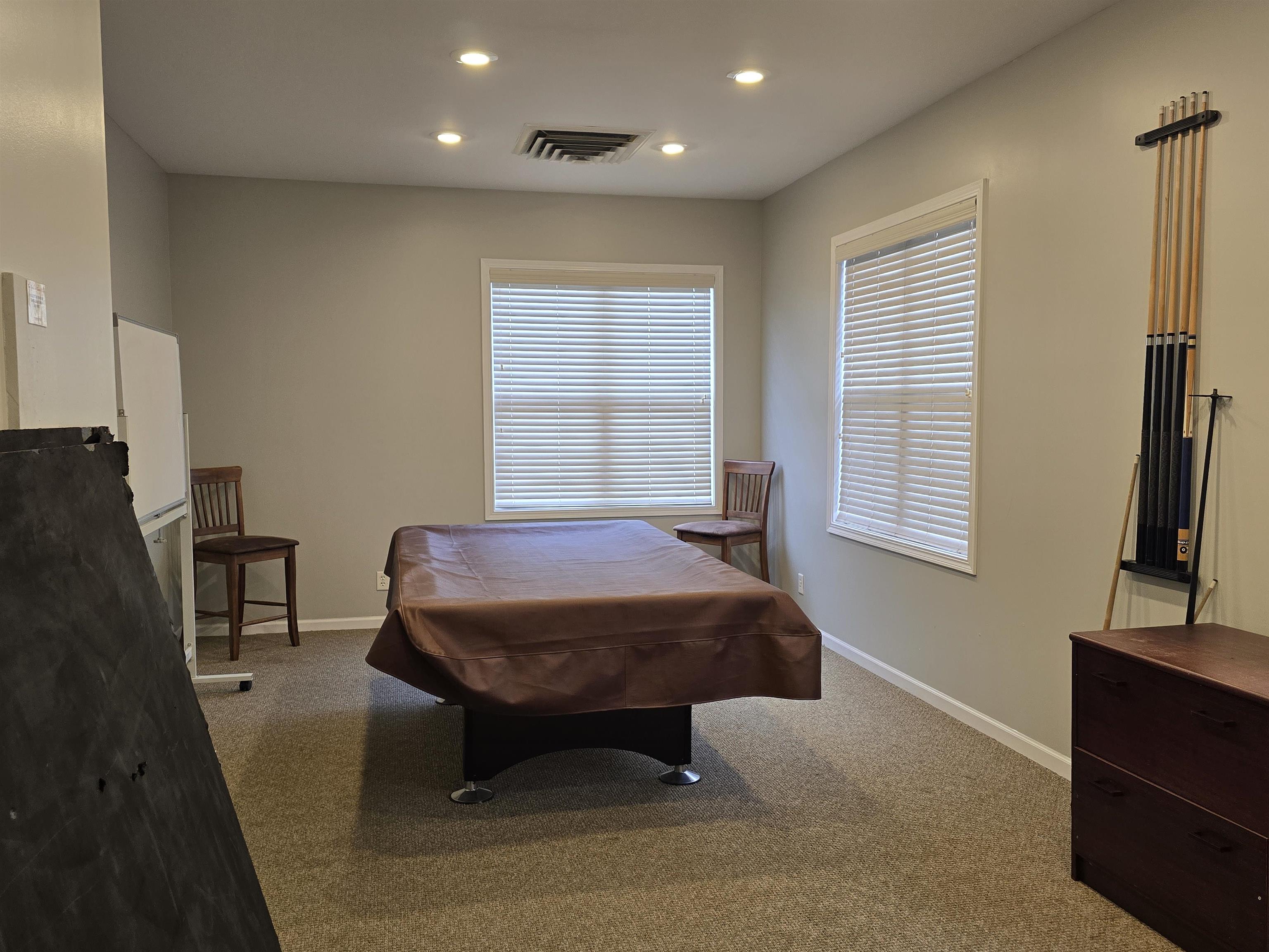 7593 Magnolia Trail Cherry Valley, IL 61016 - Photo 22 of 32 a spacious bedroom with a bed and a flat screen tv