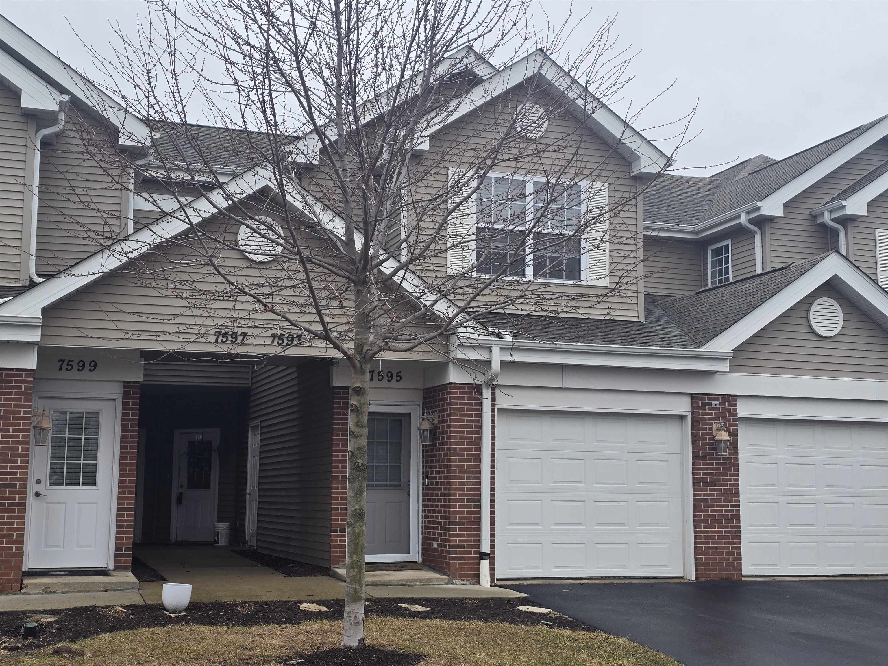 7593 Magnolia Trail Cherry Valley, IL 61016 - Photo 24 of 32 a front view of a house with a yard