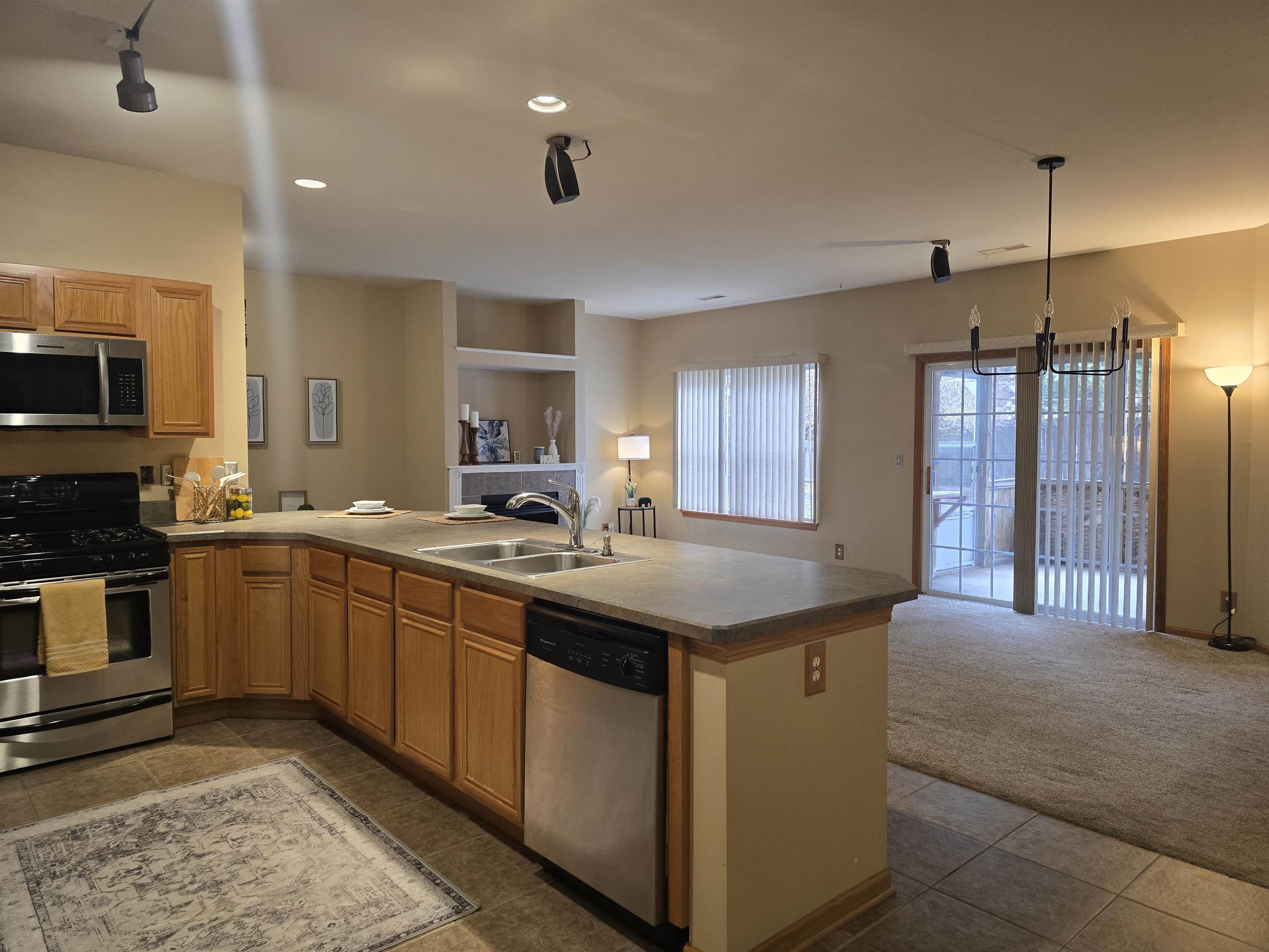 7593 Magnolia Trail Cherry Valley, IL 61016 - Photo 9 of 32 a kitchen with stainless steel appliances granite countertop a sink a stove and a refrigerator