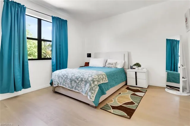 a bedroom with a bed and window