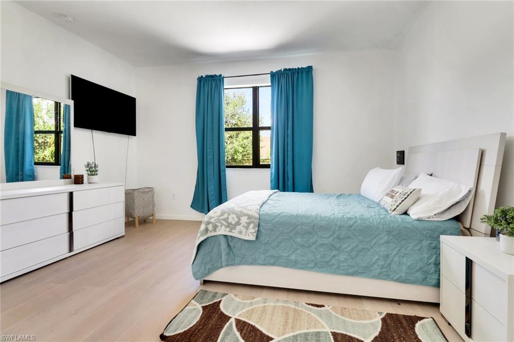 5377 Brin Way Ave Maria, FL 34142 - Photo 19 of 25 a bedroom with a bed window and flat screen tv