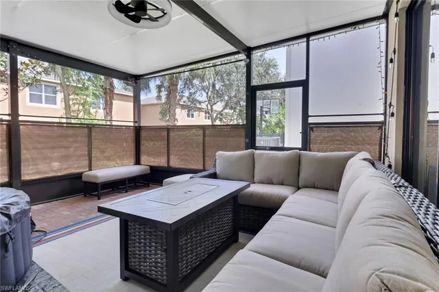 a living room with furniture and a floor to ceiling window