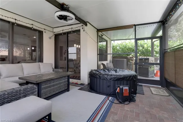 a living room with furniture and a floor to ceiling window