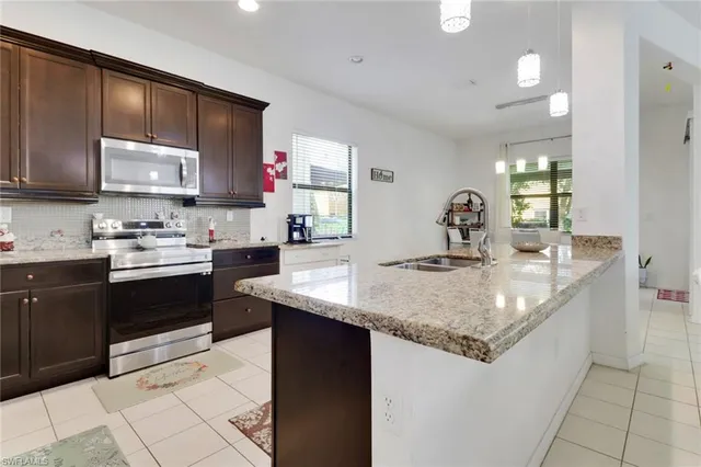 a kitchen with stainless steel appliances granite countertop a sink stove and cabinets