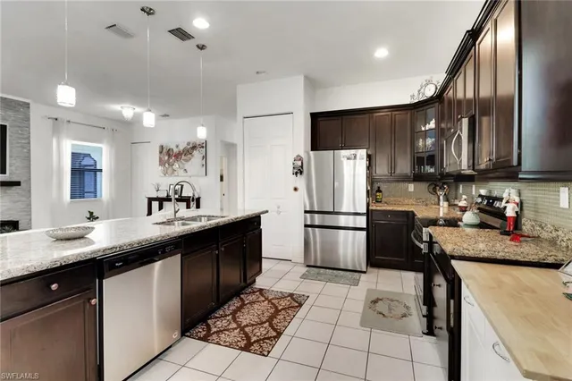 a kitchen with refrigerator cabinets and furniture